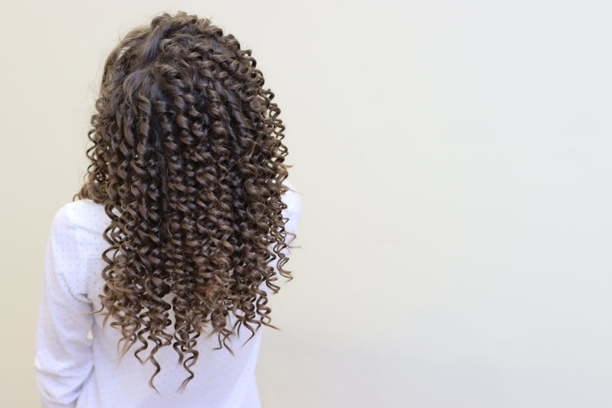 Bloomé community member with defined curls